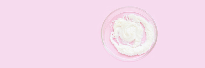 Collagen white powder. Pastel color background. Health product. Woman cosmetics concept. Sport supplement. Skincare cosmetics. Horizontal banner. Pink monochrome