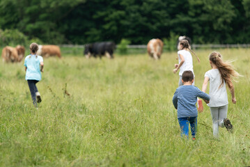 Group of kids running around on a field and having fun together