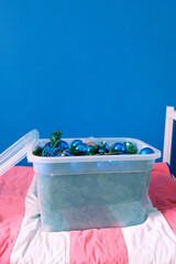 Christmas blue toys in a plastic container