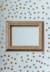 Gold frame. Golden and silver stars glitter on a white isolated background. Festive holiday backdrop. Copy space