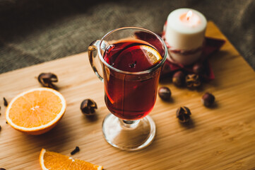 Red hot wine with spices, Christmas hot spicy drink. Seasonal mulled wine. Mulled wine with orange...