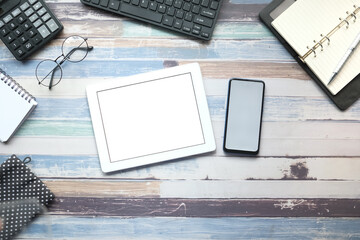 digital tablet, smart phone and stationary on wooden background 