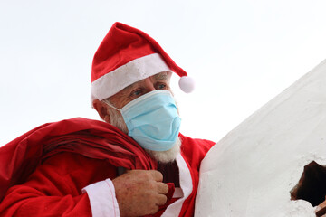 Santa Claus with mask near chimney
