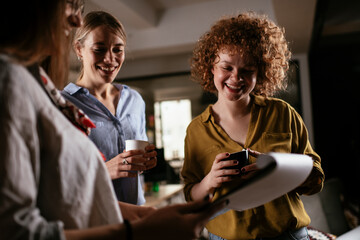 Colleagues in office talking and having fun. Friends working together..