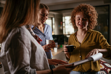 Colleagues in office talking and having fun. Friends working together..