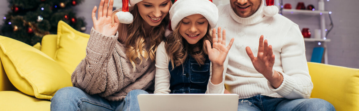 Joyful Family In Santa Hats Waving Hands While Having Video Chat On Christmas, Banner