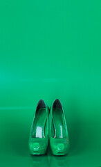 green women's shoes on a green background