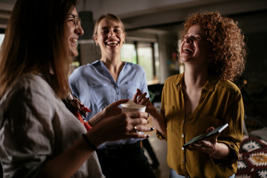 Colleagues in office talking and having fun. Friends working together..