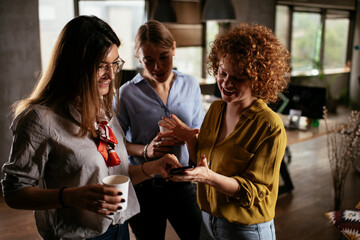 Colleagues in office talking and having fun. Friends working together..