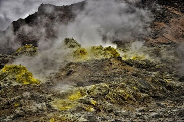 smoking volcanic valley with yellow sulfur deposits