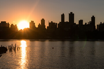 Sunset over the Silhouettes of Skyscrapers in the Upper East Side Skyline along the East River in New York City