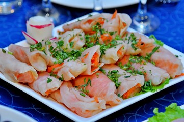 Vegetable appetizer of carrots and greens wrapped in cabbage leaves for vegetarians on a large...