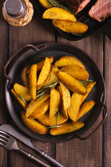 Delicious slices of baked potatoes with rosemary and oil