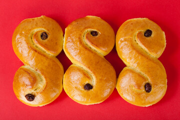 Studio photo of freshly homebaked saffron buns on red background