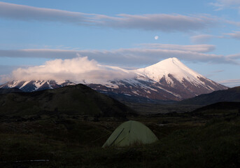 Tent against the background of Klyuchevskoy volcano, Kamchatka