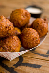 Hush puppies. Deep fried cornmeal made with onions, garlic and butter. Classic Cajun cuisine appetizer favorite. Classic New Orleans cuisine.