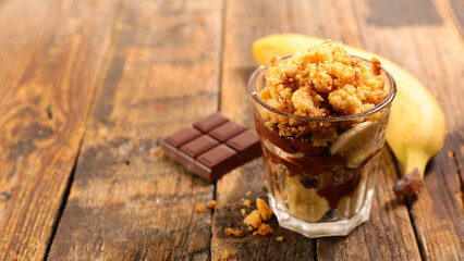 banana and chocolate crumble on wood background