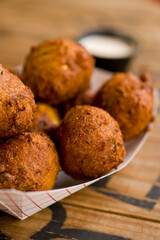 Hush puppies. Deep fried cornmeal made with onions, garlic and butter. Classic Cajun cuisine appetizer favorite. Classic New Orleans cuisine.