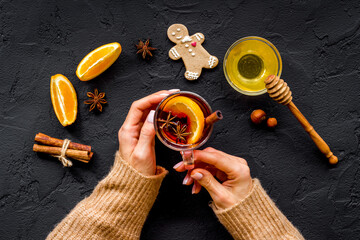 Female hands holding glass with mulled wine - Christmas hot drink