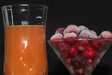 Ready acerola juice with frozen acerolas on the side. vibrant and natural colors. Rich in vitamin...