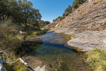 Naklejka na ściany i meble Water flowing down a ravine in the Sierra Nevada