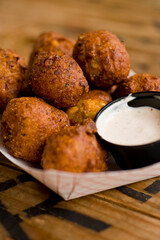 Hush puppies. Deep fried cornmeal made with onions, garlic and butter. Classic Cajun cuisine appetizer favorite. Classic New Orleans cuisine.