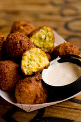 Hush puppies. Deep fried cornmeal made with onions, garlic and butter. Classic Cajun cuisine appetizer favorite. Classic New Orleans cuisine.