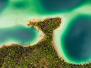 Aerial view of colorful pond in the marshlands during a fall season day. Taken in Yukon, Canada.