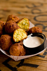 Hush puppies. Deep fried cornmeal made with onions, garlic and butter. Classic Cajun cuisine appetizer favorite. Classic New Orleans cuisine.