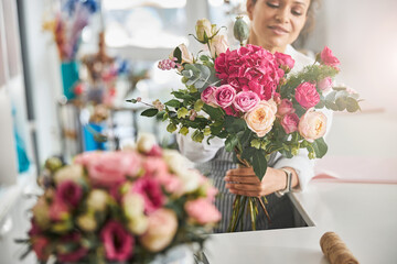 Professional florist posing with a gorgeous floral composition