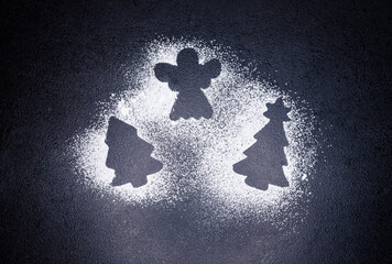 Christmas tree and angel from flour on a gray concrete background