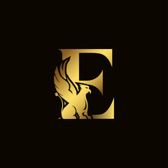 Griffin silhouette inside gold letter E. Heraldic symbol beast ancient mythology or fantasy. Creative design elements for logotype, emblem, monogram, icon or symbol for company, corporate, brand name.