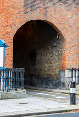 Dark alley, arched lane way,between old red brick buildings in Dublin street. Ireland