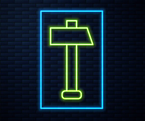 Glowing neon line Hammer icon isolated on brick wall background. Tool for repair. Vector Illustration.