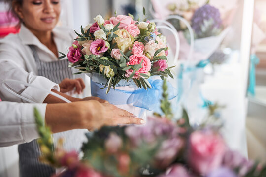 Flower shop staff getting bouquets ready for selling