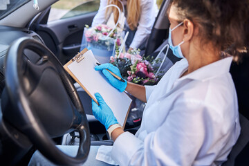 Female florist going on a bouquet delivery duty