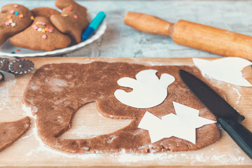 Halloween ginger cookies. Making homemade gingerbread cookies for Halloween. Halloween cookies on textured. Funny ginger biscuits.