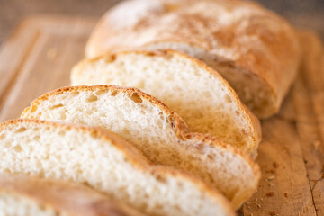 sliced artisan bread on a wooden cutting board
