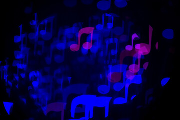 Garland in the form of notes shines on a black background.