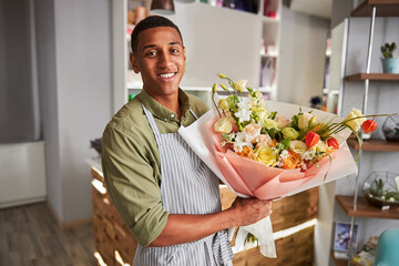 Joyous floral specialist with a flower bouquet