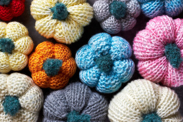 Texture from multicolored handmade crochet pumpkins for fall holidays decoration (Halloween, Thanksgiving Day)