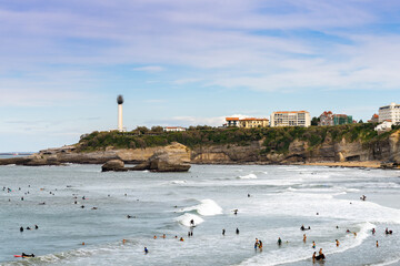 many surfers enjoy the waves on the Grand Plage in Biarritz