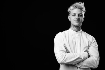 Young handsome rebellious businessman with blond hair in black and white