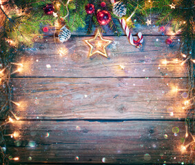 Rustic Christmas Board - Fir Branches And String Light On Wooden Plank With Defocused Abstract...