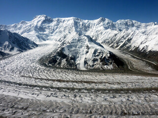 Pobeda Peak - 7439 m viewed from helicopter. Zviozdochka and Diki glaciers flow down into Inylchek...