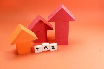 Block letters on tax and arrows pointing up on the orange background