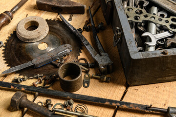 Variety of old vintage household hand tools still life on a wooden background in a DIY and repair concept