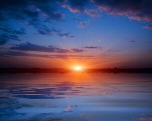Naklejka na ściany i meble sunset over lake water surface