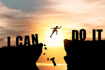 Fototapeta Silhouette man jumping over cliffs for I can do it , good mindset by never give up concept. obraz