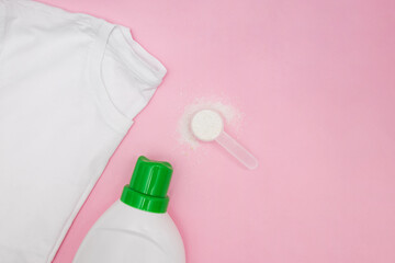 Washing liquid , powder detergent and clean t-shirt on pink background